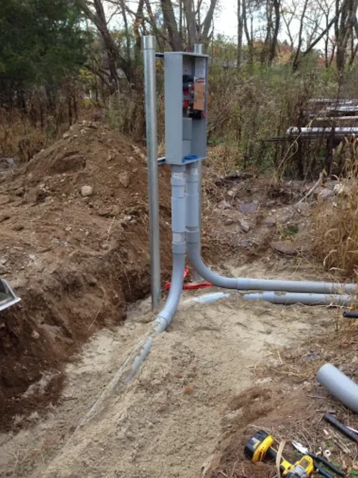 Underground electrical service riser and meter box in a trench
